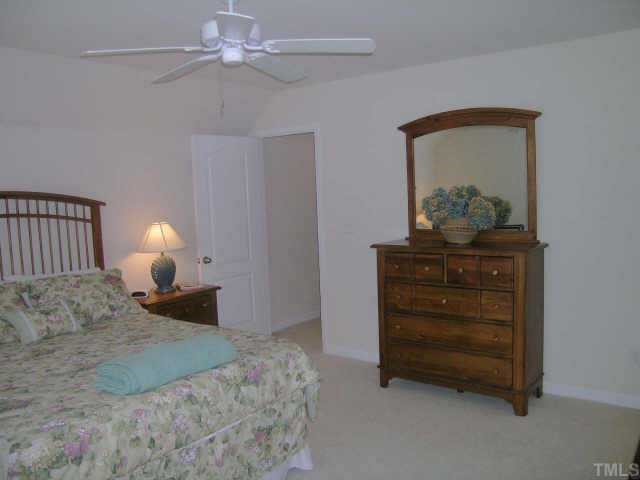3405 Parlor Street Raleigh, NC 27614 - Photo 8 of 10 a bedroom with a bed and a lamp on dresser
