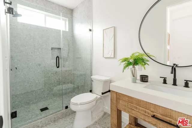a view of a hallway with wooden floor and entryway