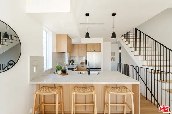 a kitchen with cabinets and stainless steel appliances