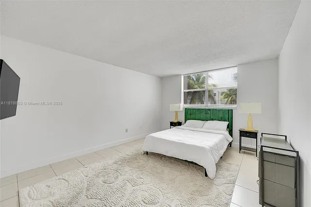 a bathroom with a sink a mirror and a bath tub