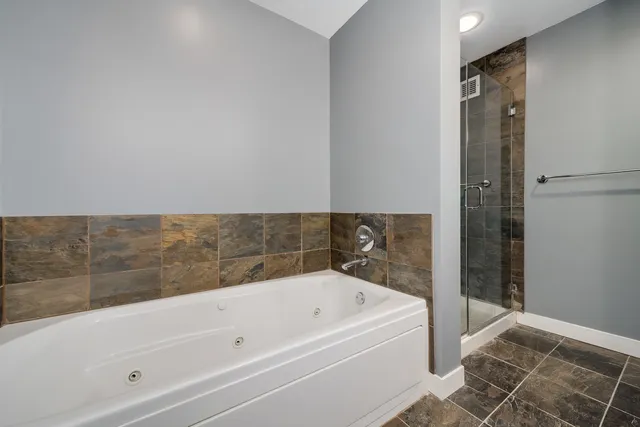 a bathroom with a bathtub and shower