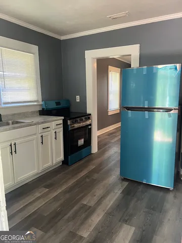a kitchen with a refrigerator and a sink
