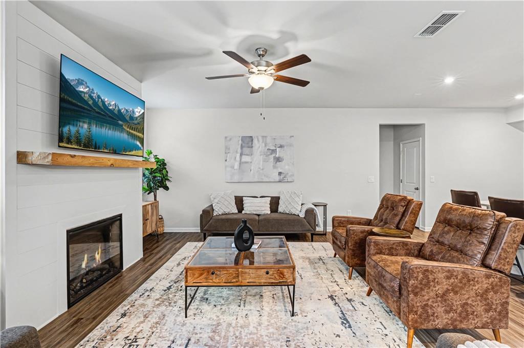 33 Brookside Way Cartersville, GA 30121 - Photo 11 of 54 a living room with furniture a flat screen tv and a fireplace