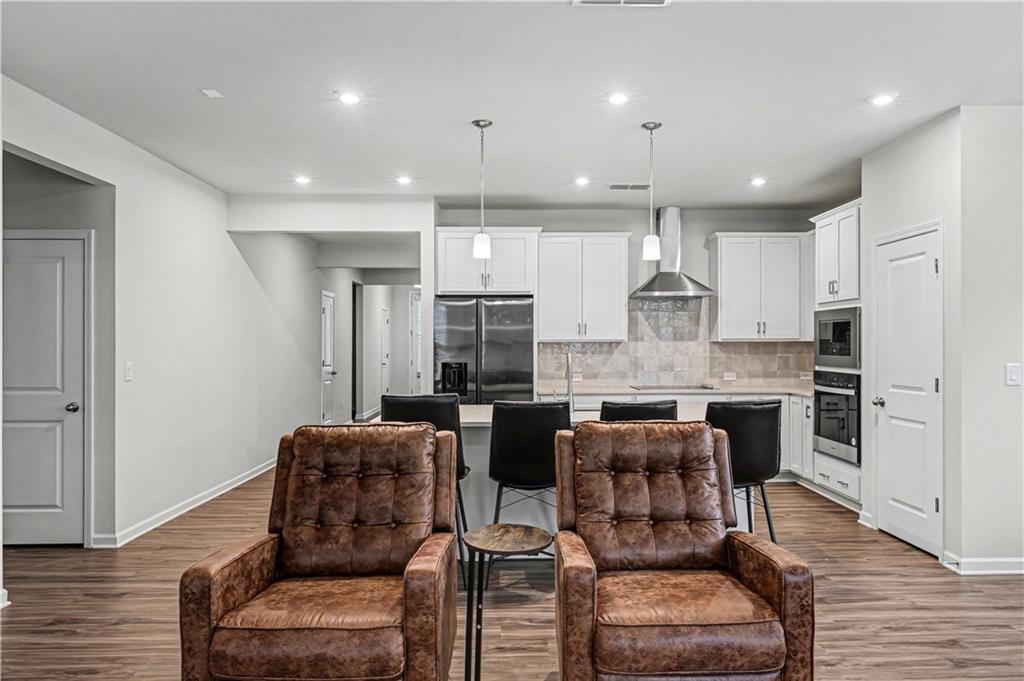 33 Brookside Way Cartersville, GA 30121 - Photo 14 of 54 a kitchen with stainless steel appliances kitchen island granite countertop a refrigerator and a stove top oven with wooden floor