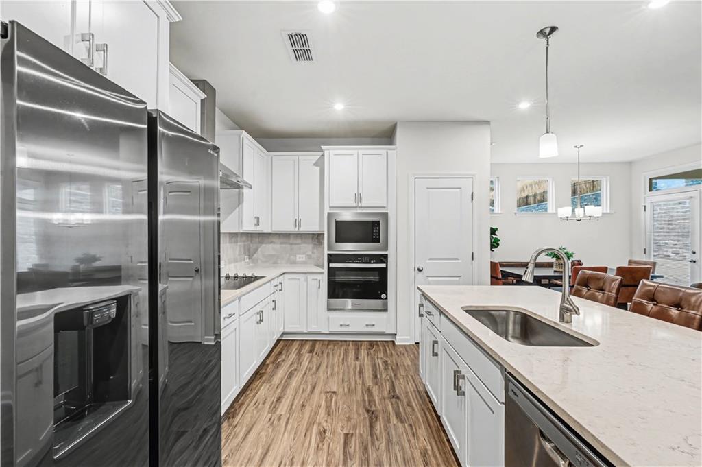 33 Brookside Way Cartersville, GA 30121 - Photo 18 of 54 a kitchen with kitchen island a counter top space a sink stainless steel appliances and cabinets