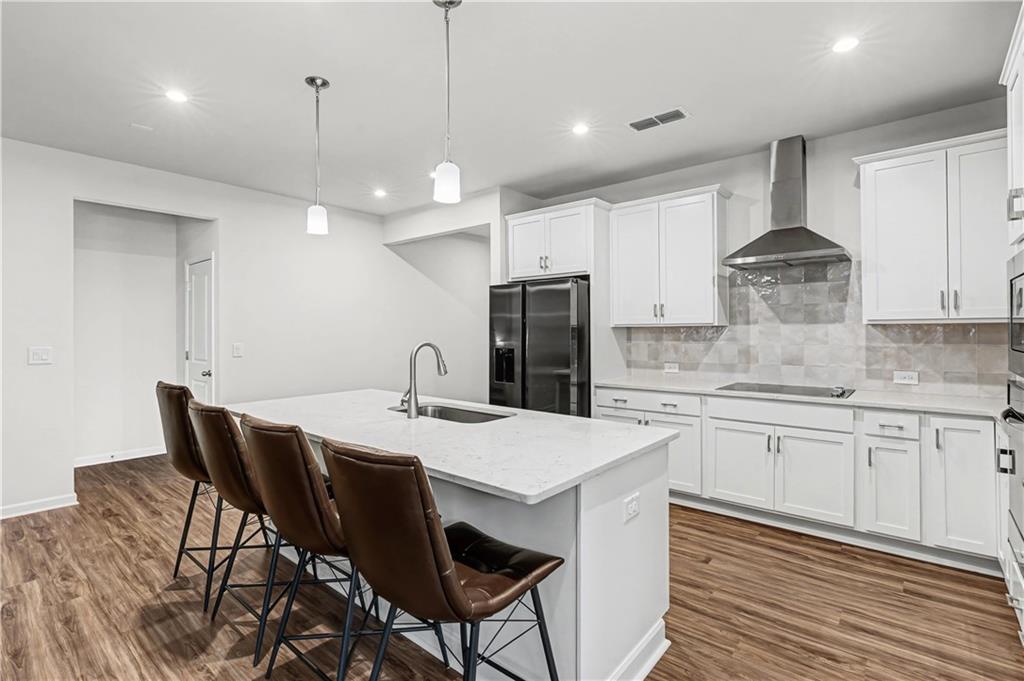 33 Brookside Way Cartersville, GA 30121 - Photo 20 of 54 a kitchen with stainless steel appliances kitchen island granite countertop a table chairs stove and white cabinets