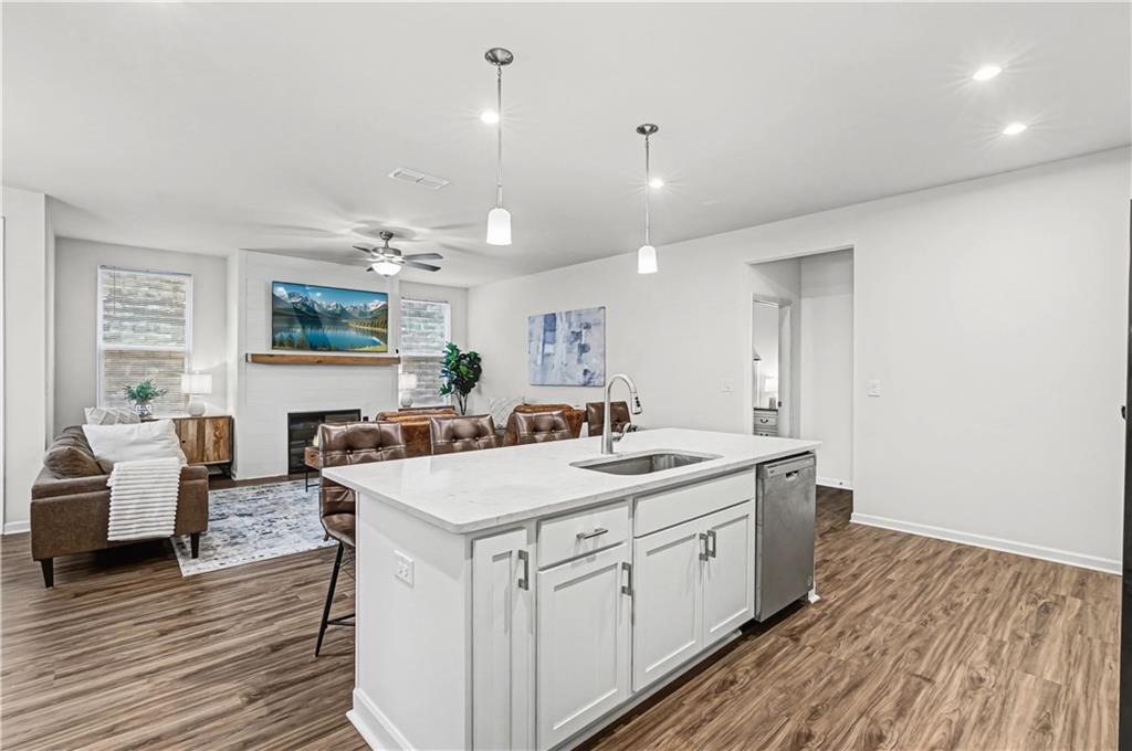 33 Brookside Way Cartersville, GA 30121 - Photo 22 of 54 a large white kitchen with a stove a sink dishwasher and a refrigerator with wooden floor