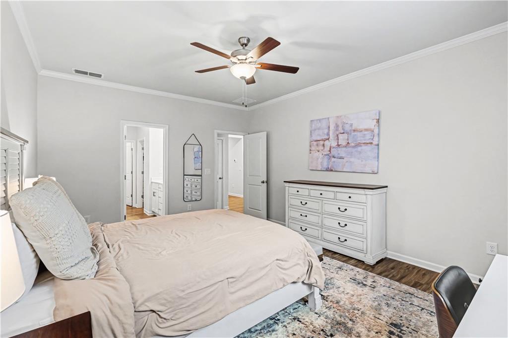 33 Brookside Way Cartersville, GA 30121 - Photo 26 of 54 a bedroom with a bed a chandelier and a dresser