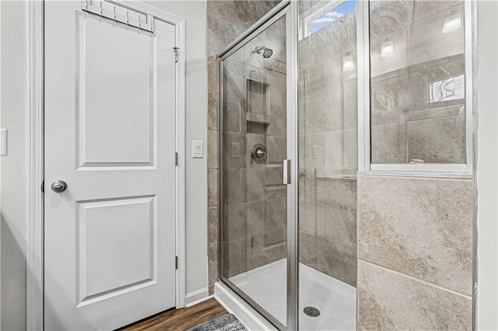 33 Brookside Way Cartersville, GA 30121 - Photo 29 of 54 a bathroom with a glass shower door