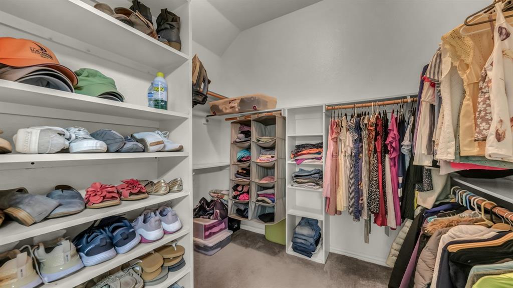 203 Mockingbird Lane Aledo, TX 76008 - Photo 28 of 37 Custom closet system featuring extensive shelving, multiple hanging rods, and built-in storage compartments
