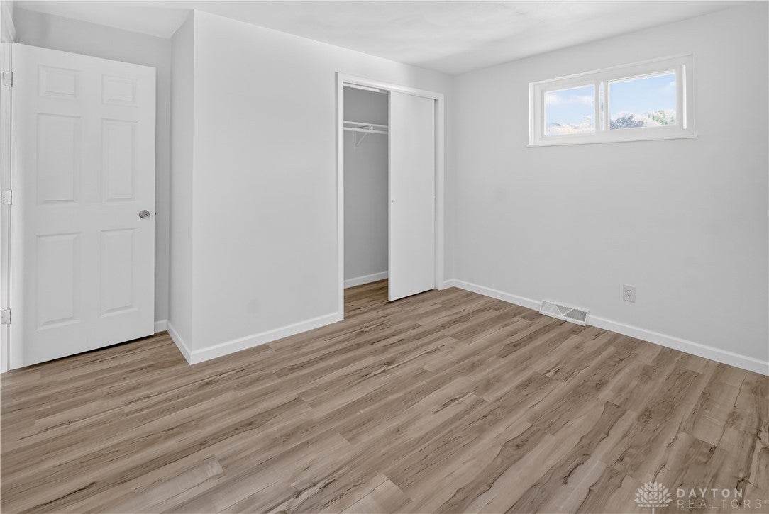 1243 Student Avenue Springfield, OH 45503 - Photo 23 of 38 Smooth wood-look flooring and a recessed closet define this versatile room.