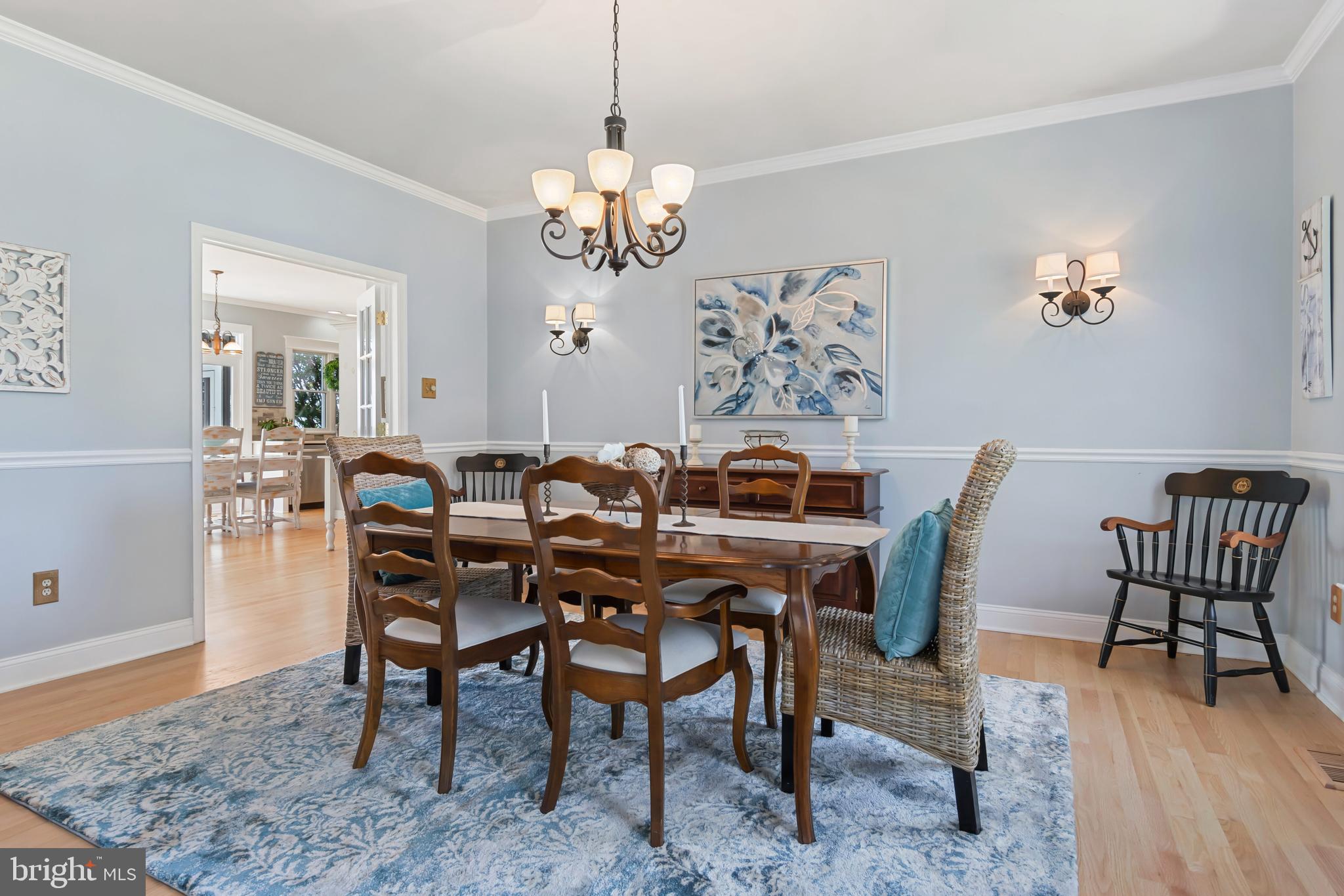 2861 Cox Neck Road Chester, MD 21619 - Photo 19 of 79 a view of a dining room with furniture wooden floor and a chandelier