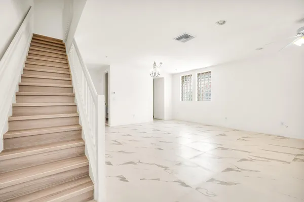 a view of an empty room with stairs