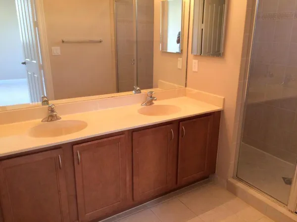 a bathroom with a shower and a sink