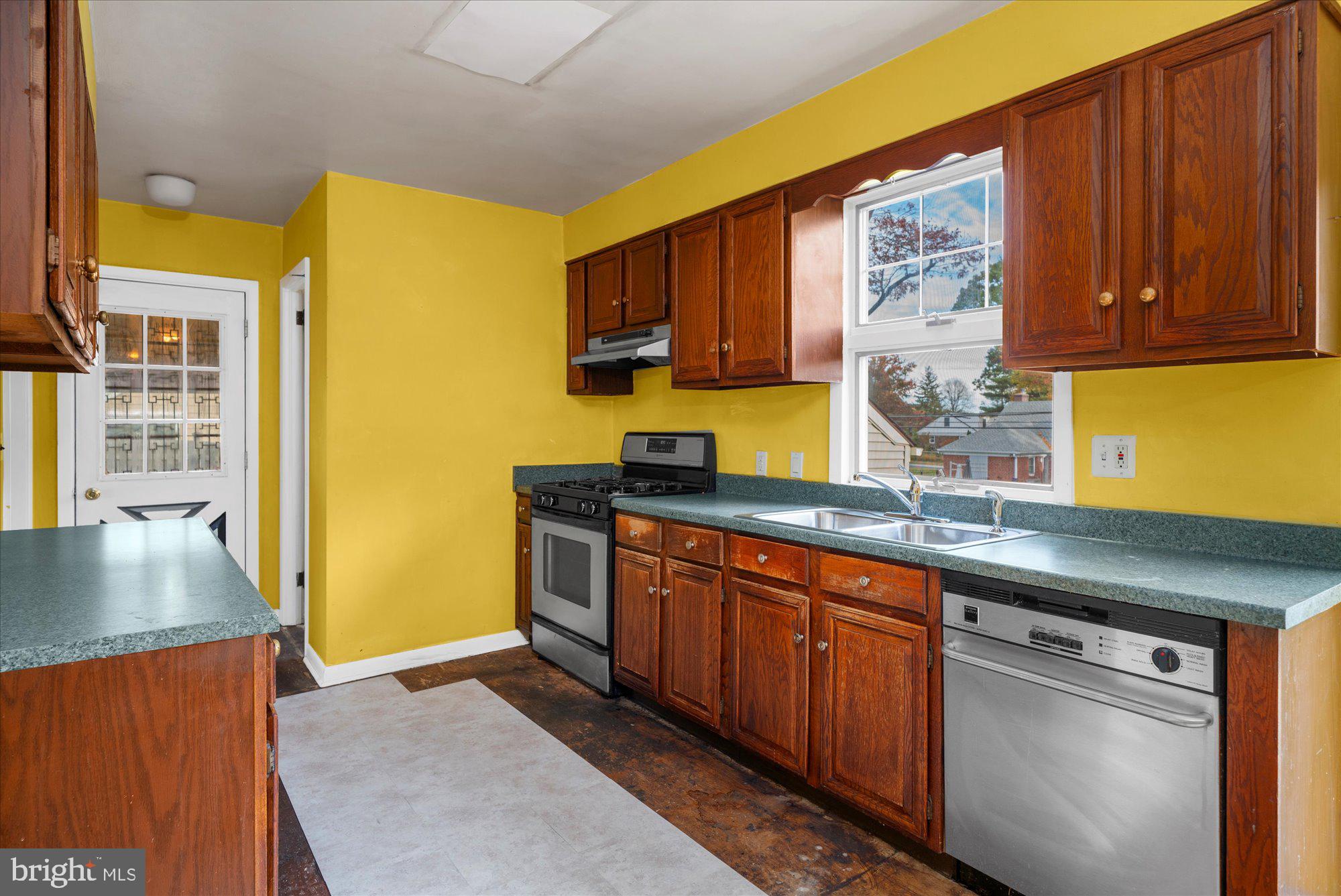 821 Coopertown Road Bryn Mawr, PA 19010 - Photo 12 of 44 a kitchen with stainless steel appliances granite countertop wooden cabinets a sink and a window