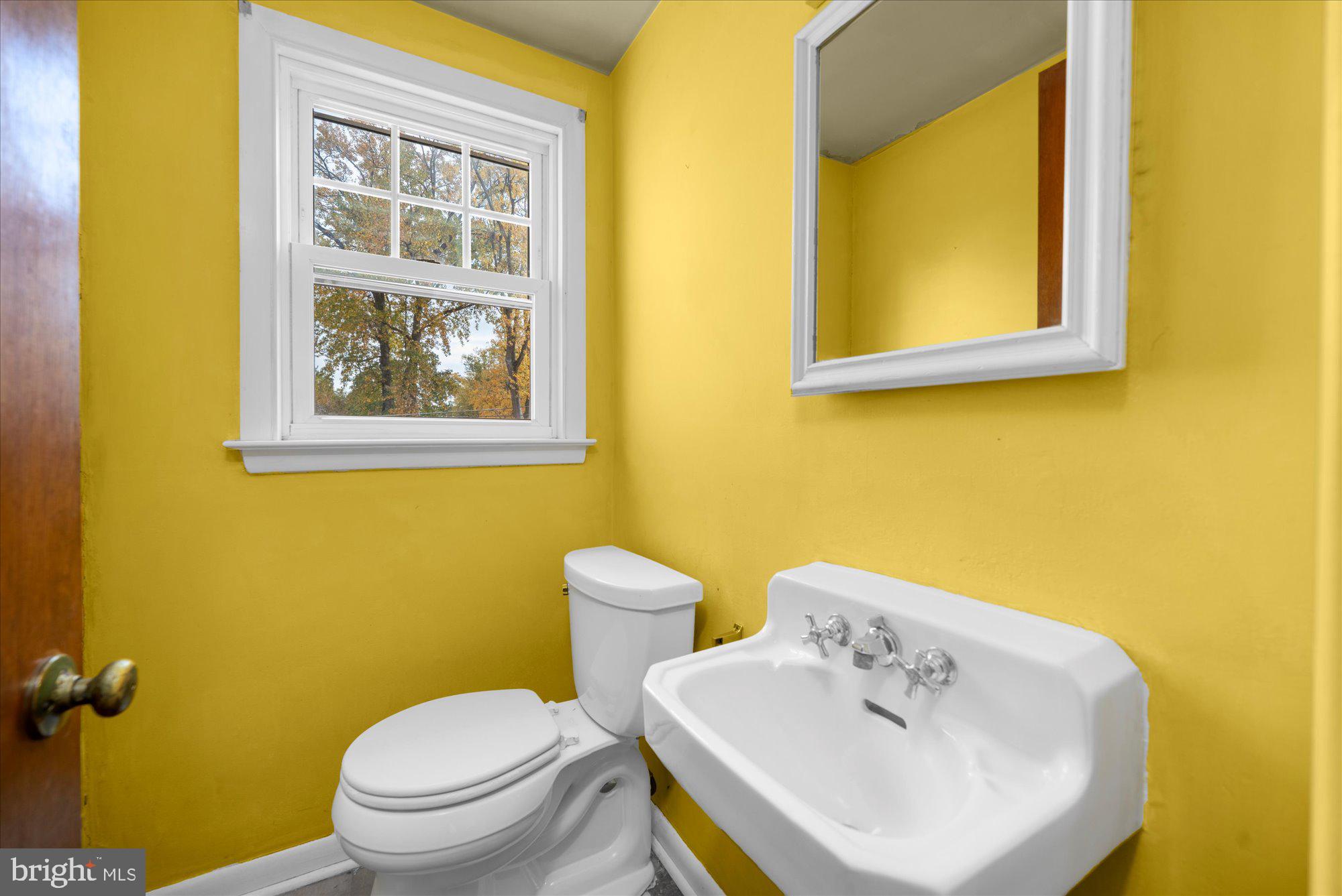 821 Coopertown Road Bryn Mawr, PA 19010 - Photo 16 of 44 a bathroom with a toilet sink and mirror