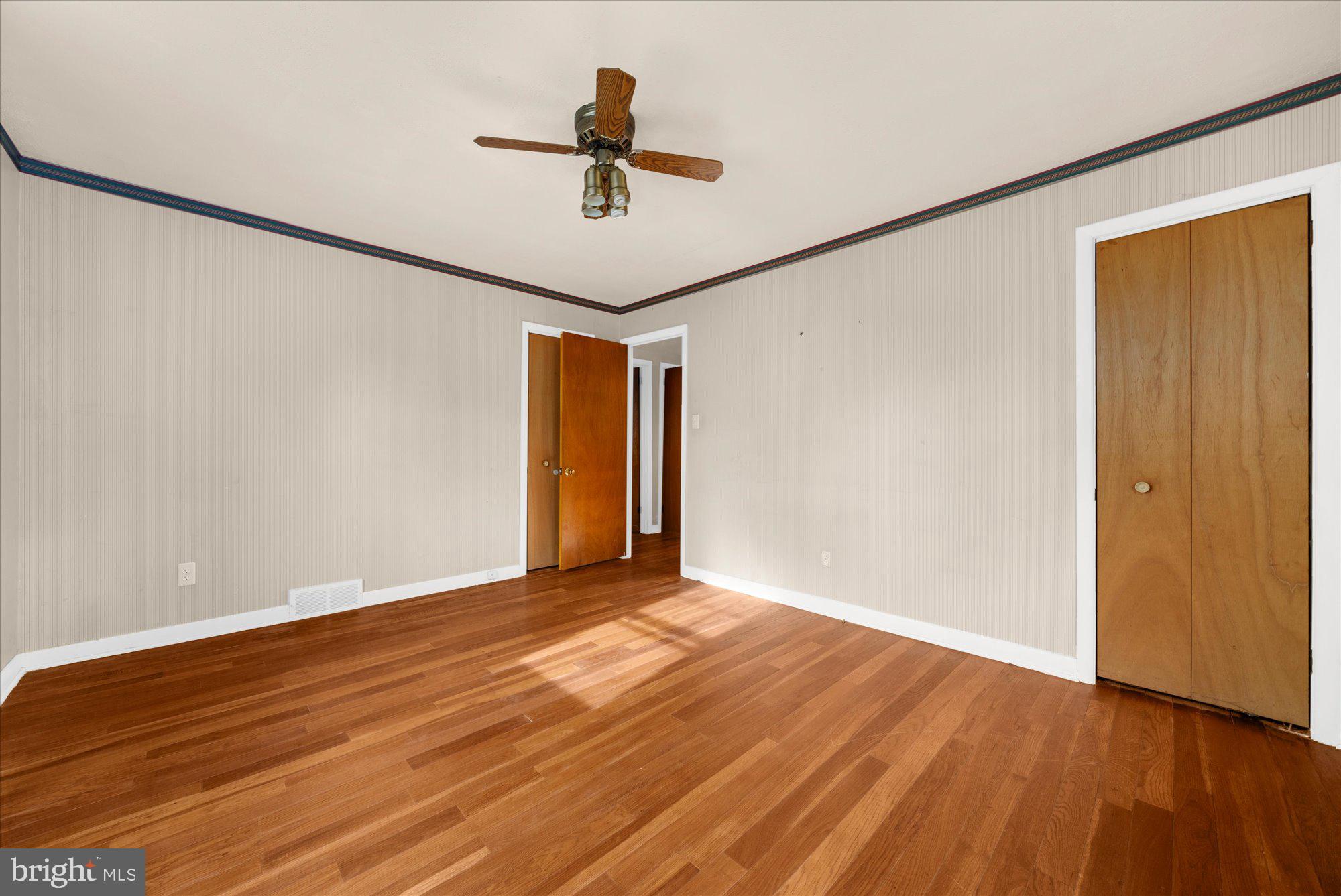 821 Coopertown Road Bryn Mawr, PA 19010 - Photo 18 of 44 a view of empty room with wooden floor and fan