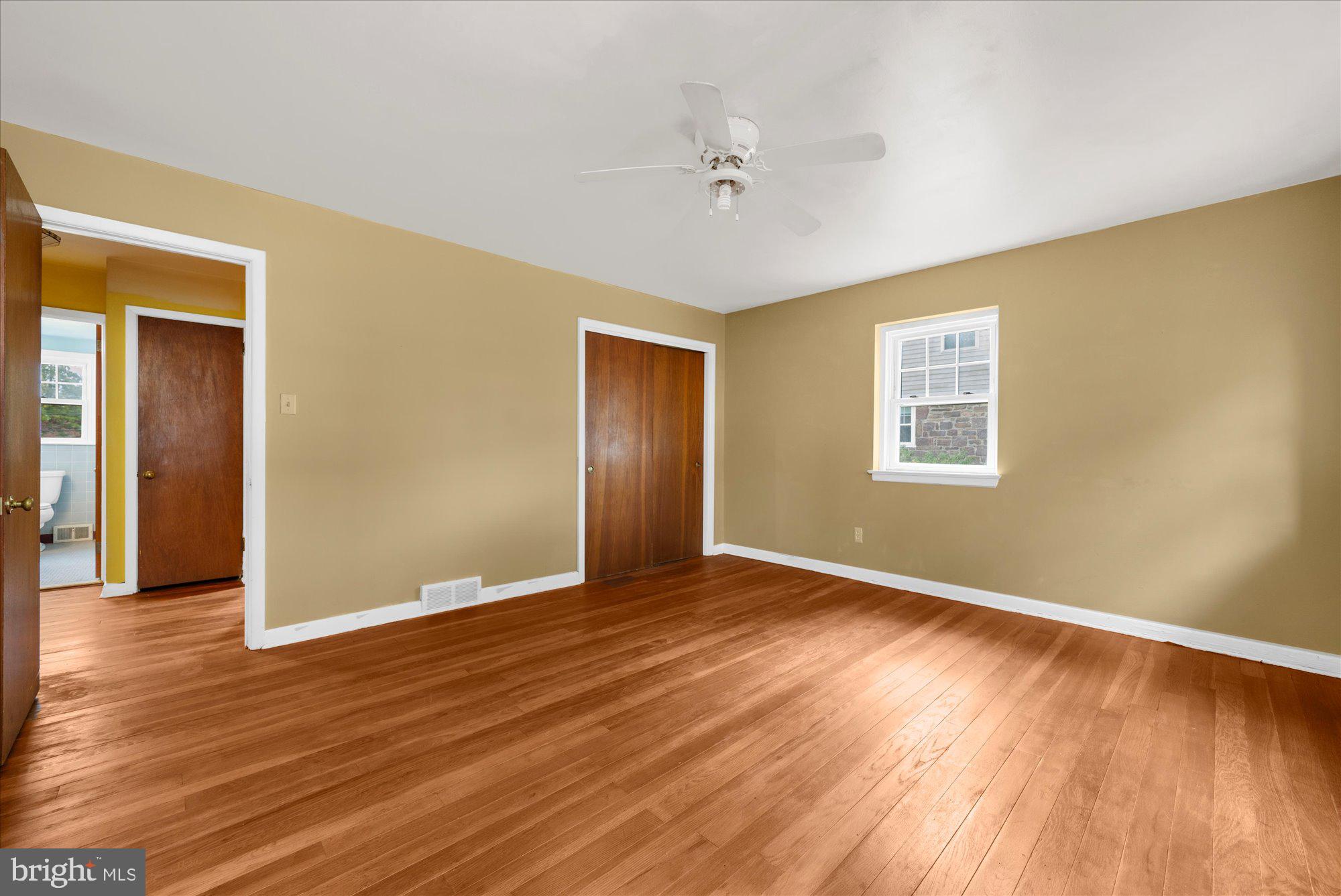 821 Coopertown Road Bryn Mawr, PA 19010 - Photo 20 of 44 a view of an empty room with wooden floor and a window