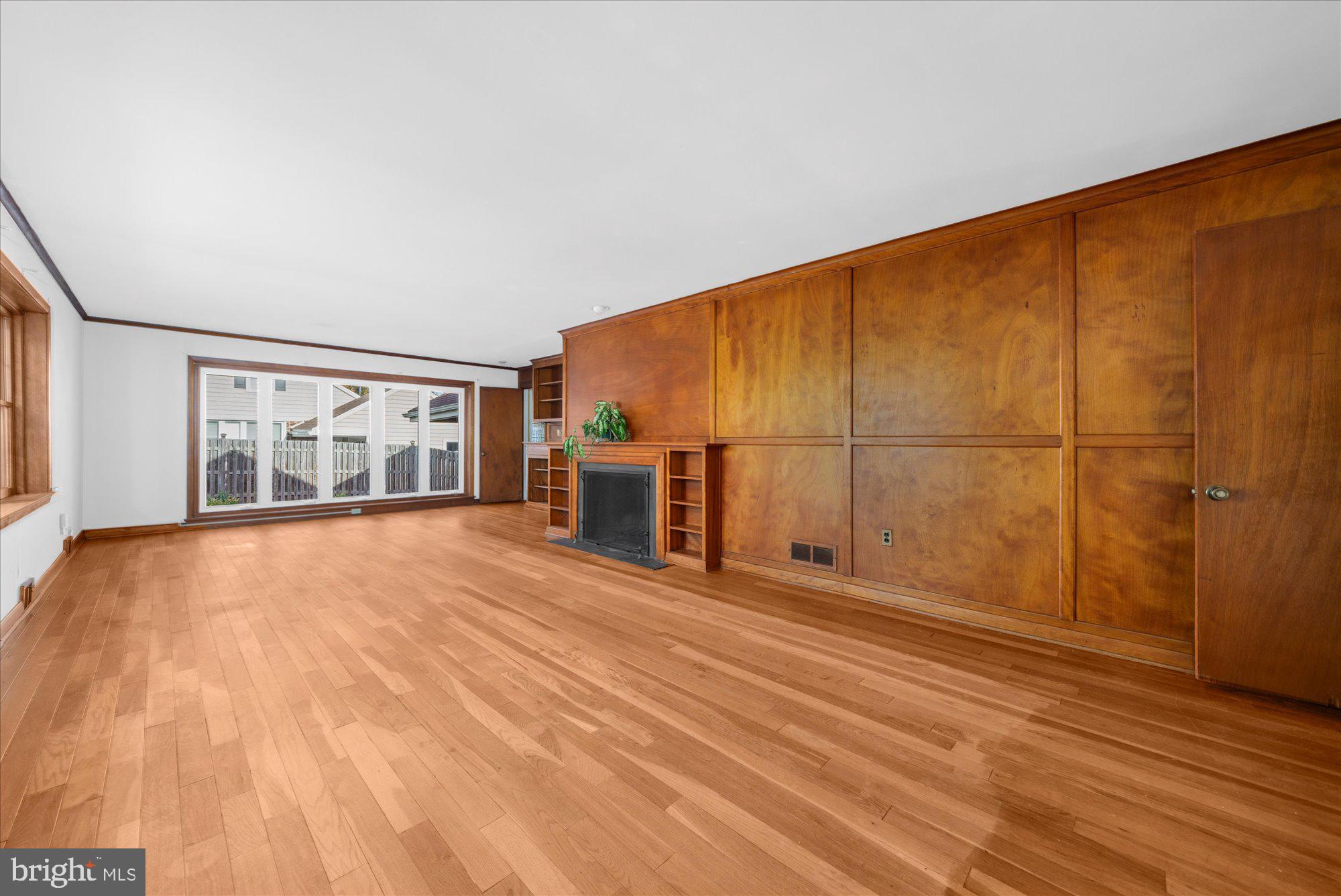 821 Coopertown Road Bryn Mawr, PA 19010 - Photo 7 of 44 an empty room with wooden floor and windows