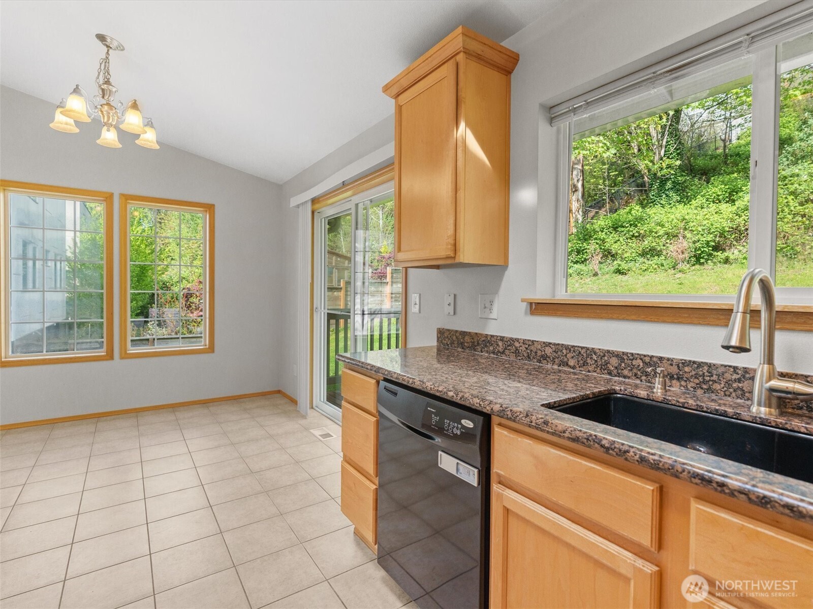 5062 23rd Avenue Southwest Seattle, WA 98106 - Photo 15 of 39 a kitchen with granite countertop a sink and a window