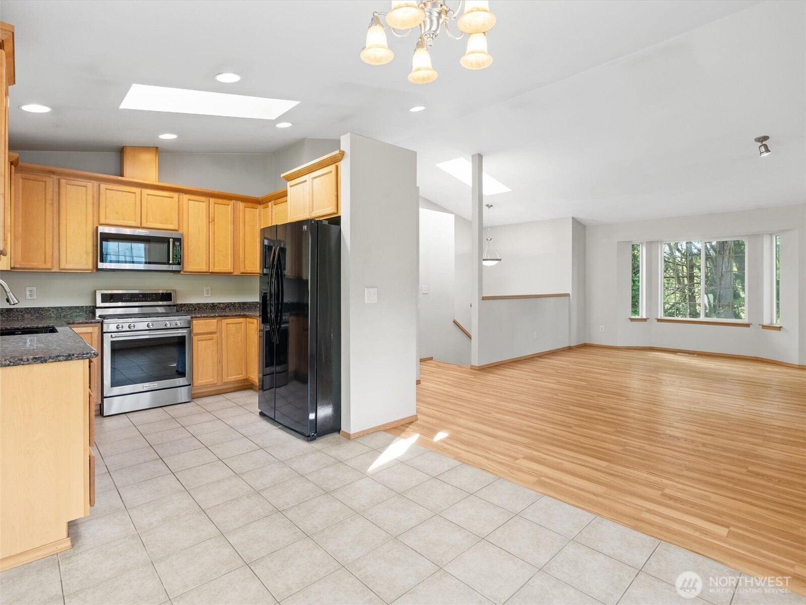 5062 23rd Avenue Southwest Seattle, WA 98106 - Photo 16 of 39 a kitchen with stainless steel appliances granite countertop a refrigerator and a stove top oven