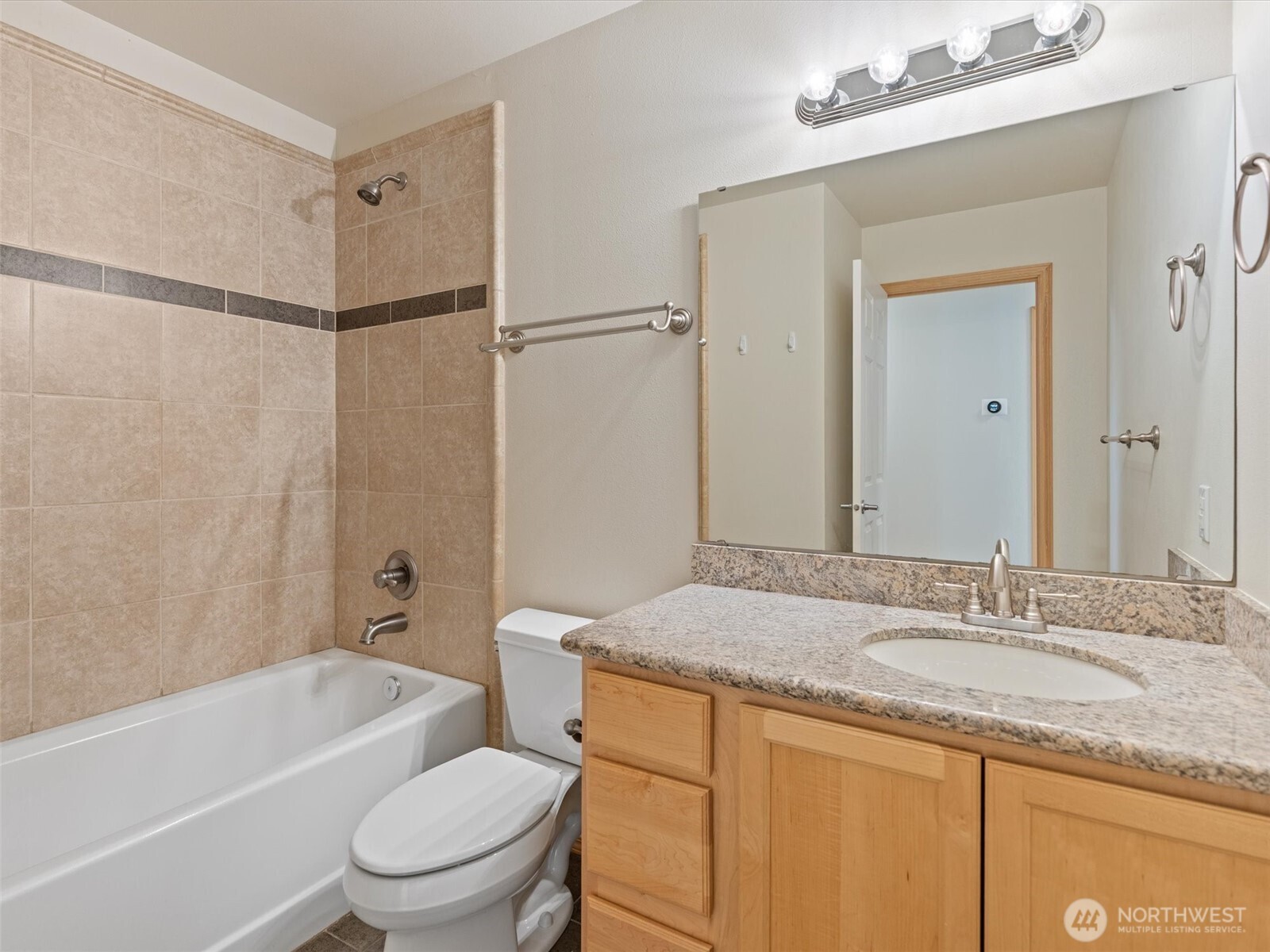5062 23rd Avenue Southwest Seattle, WA 98106 - Photo 19 of 39 a bathroom with a granite countertop sink toilet and shower