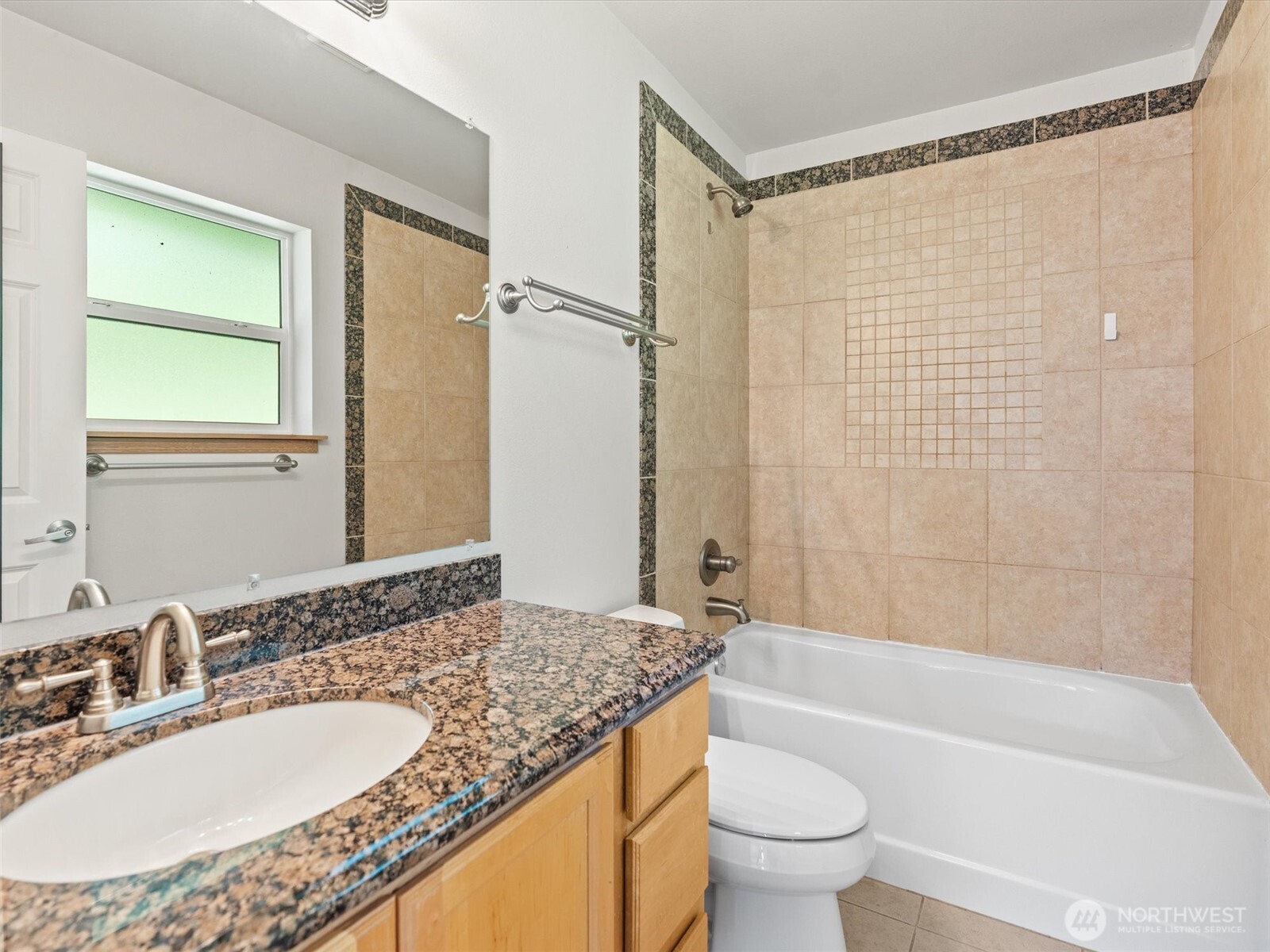 5062 23rd Avenue Southwest Seattle, WA 98106 - Photo 26 of 39 a bathroom with a granite countertop sink toilet and shower
