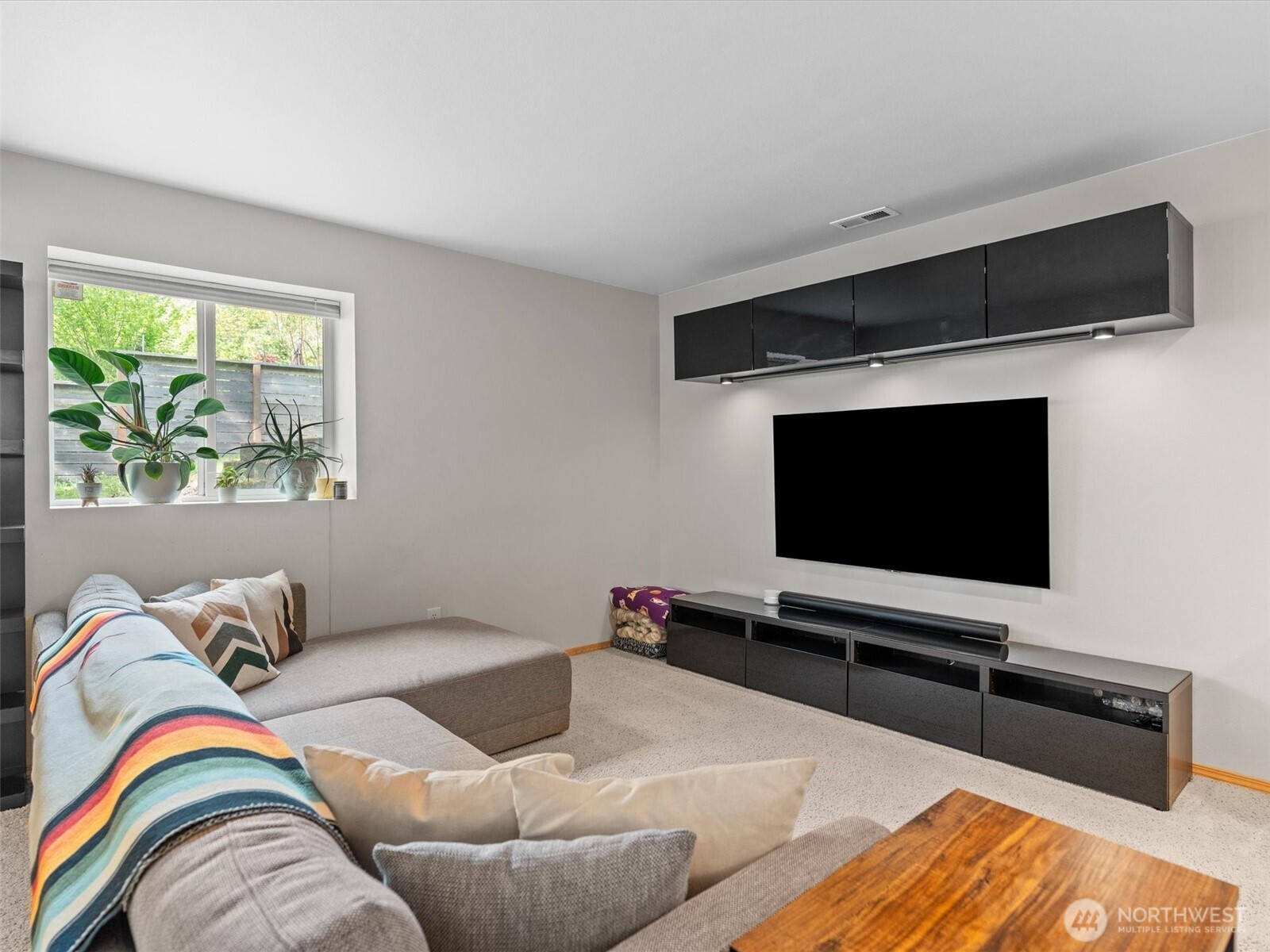 5062 23rd Avenue Southwest Seattle, WA 98106 - Photo 29 of 39 a living room with furniture and a flat screen tv