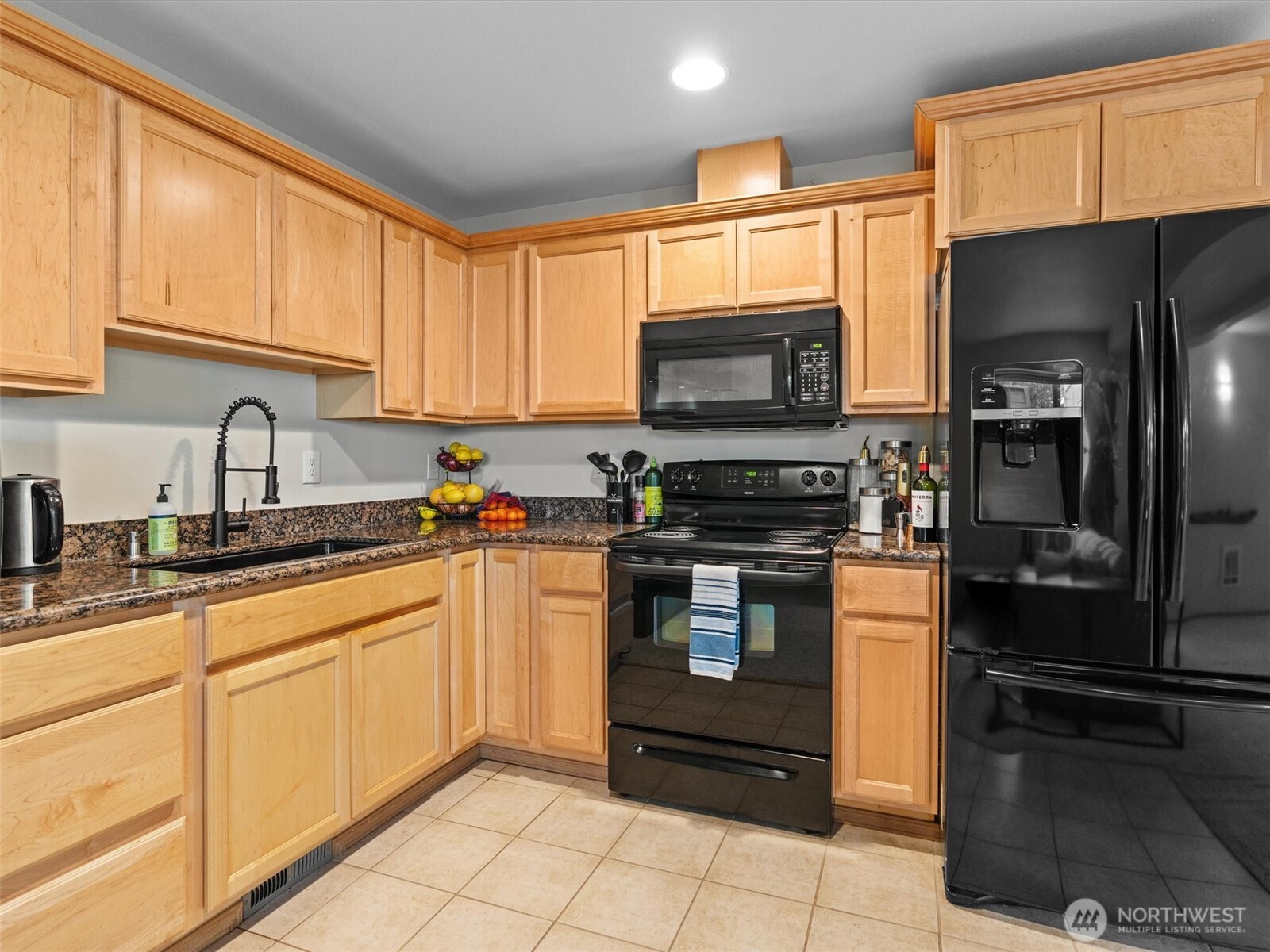 5062 23rd Avenue Southwest Seattle, WA 98106 - Photo 31 of 39 a kitchen with a sink microwave and refrigerator