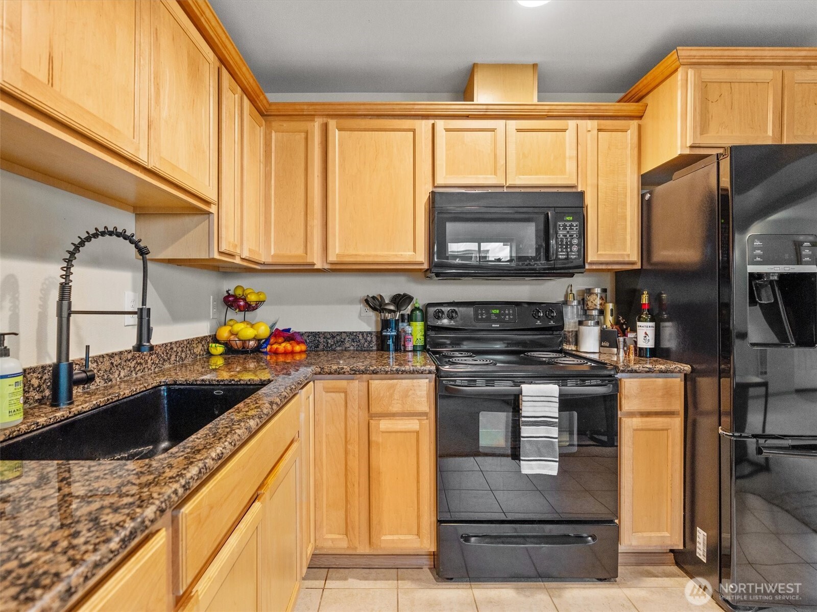 5062 23rd Avenue Southwest Seattle, WA 98106 - Photo 32 of 39 a kitchen with a sink a stove and cabinets