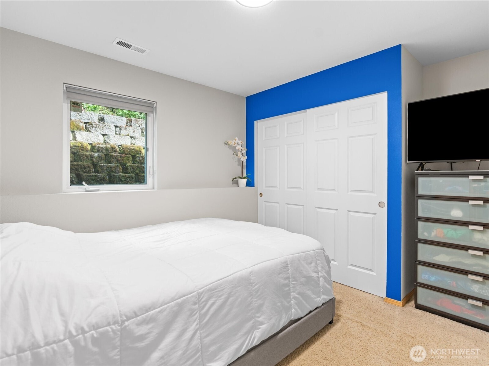 5062 23rd Avenue Southwest Seattle, WA 98106 - Photo 35 of 39 a bedroom with a bed and a flat screen tv