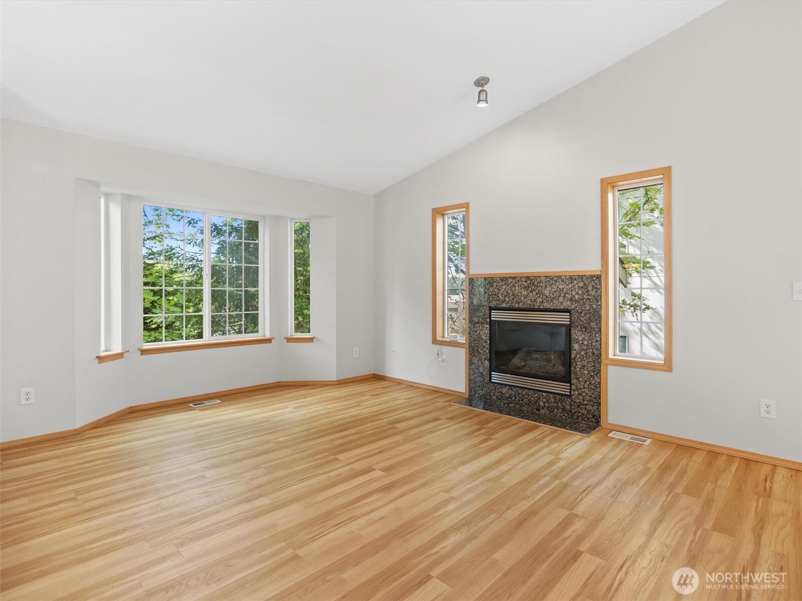 5062 23rd Avenue Southwest Seattle, WA 98106 - Photo 5 of 39 a view of empty room with a fireplace and windows