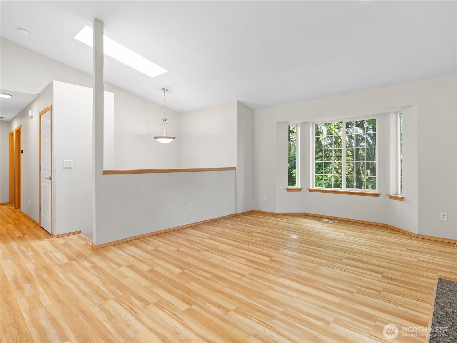 5062 23rd Avenue Southwest Seattle, WA 98106 - Photo 7 of 39 a view of an empty room with wooden floor and a window