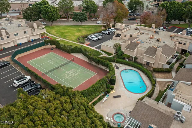an aerial view of a house with a swimming pool patio and outdoor seating
