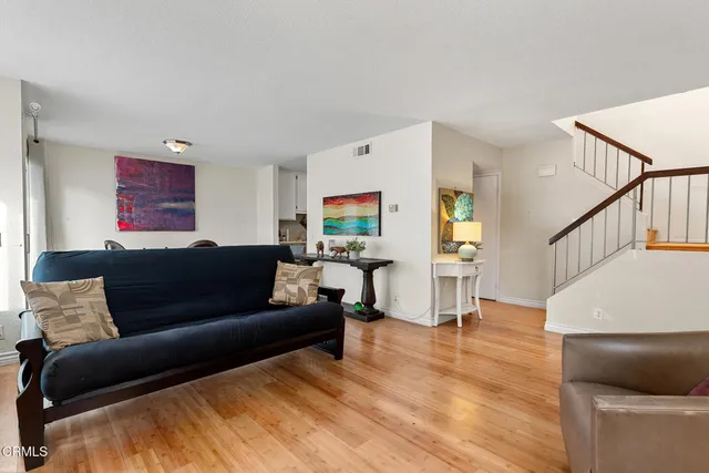 a living room with furniture and wooden floor