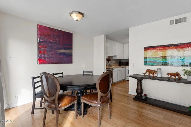 a view of a dining room with furniture and wooden floor