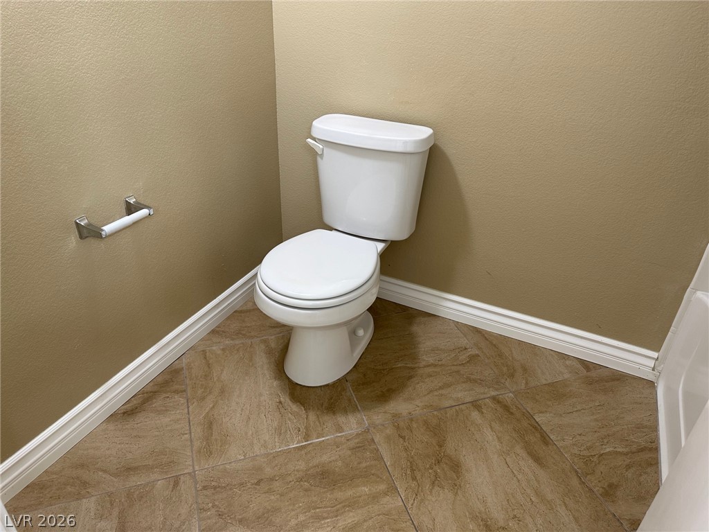 7255 West Sunset Road, Unit 2078 Las Vegas, NV 89113 - Photo 14 of 34 A well-maintained commode area features practical tile flooring and crisp baseboard trim.