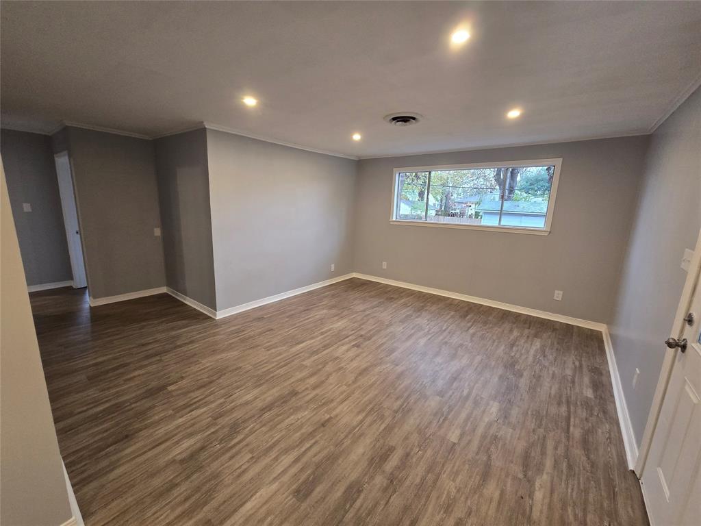 233 Roma Drive Shreveport, LA 71105 - Photo 4 of 12 Unfurnished room featuring recessed lighting, dark wood-style floors, and crown molding