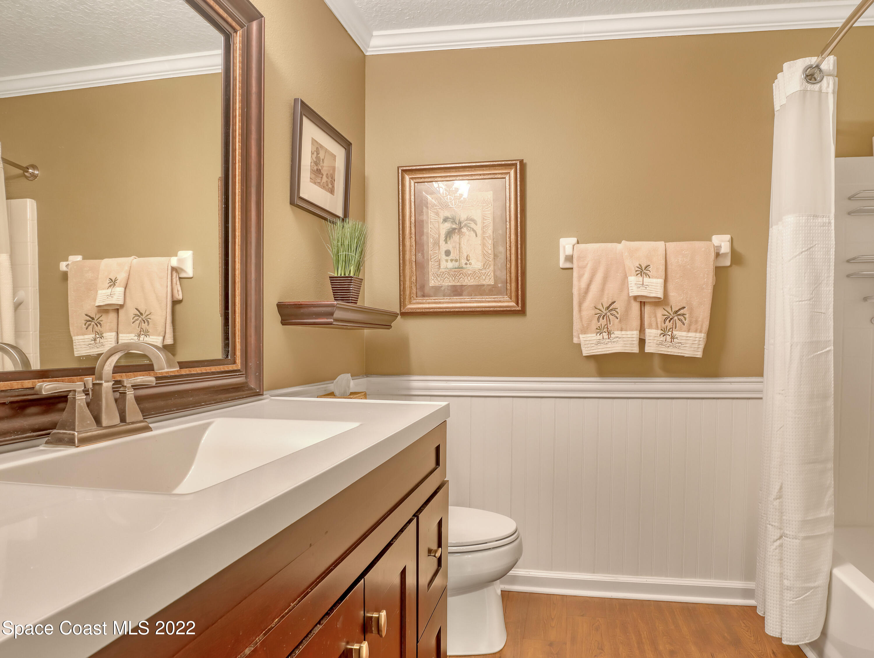 4077 Meander Place Rockledge, FL 32955 - Photo 13 of 24 a bathroom with a sink a toilet a mirror and a window