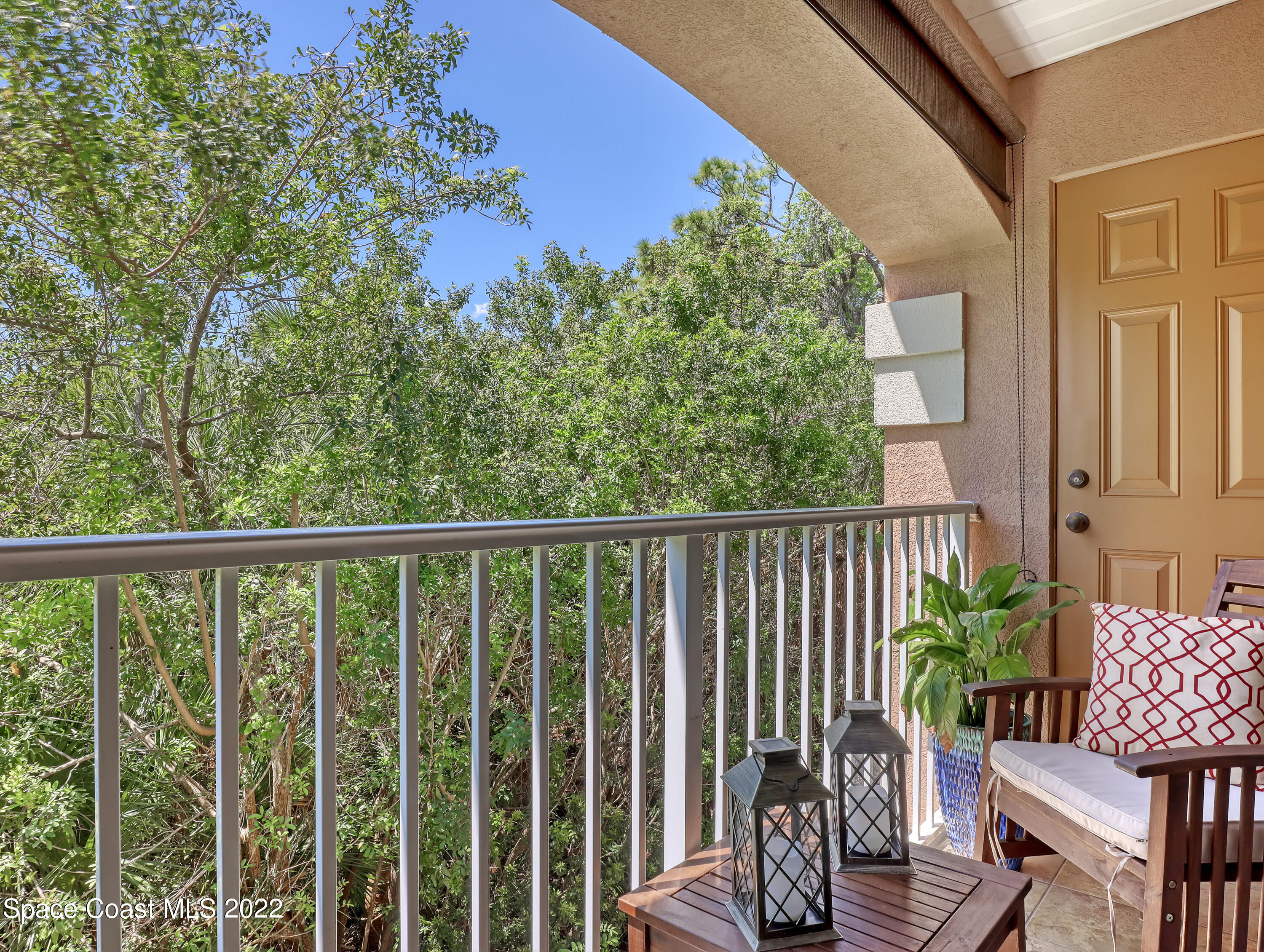 4077 Meander Place Rockledge, FL 32955 - Photo 16 of 24 a balcony with wooden floor table and chairs