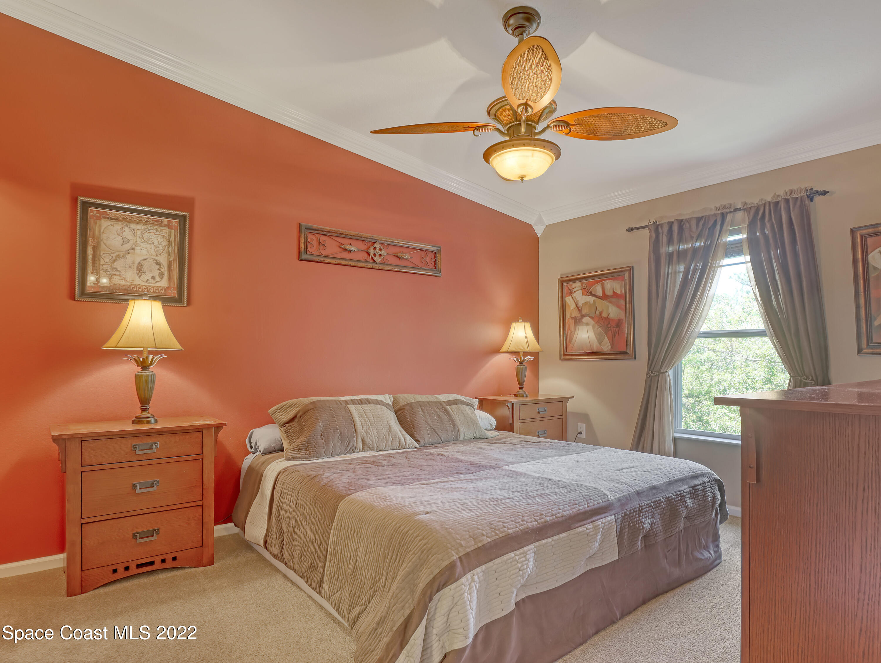 4077 Meander Place Rockledge, FL 32955 - Photo 9 of 24 a bedroom with a bed and a chandelier