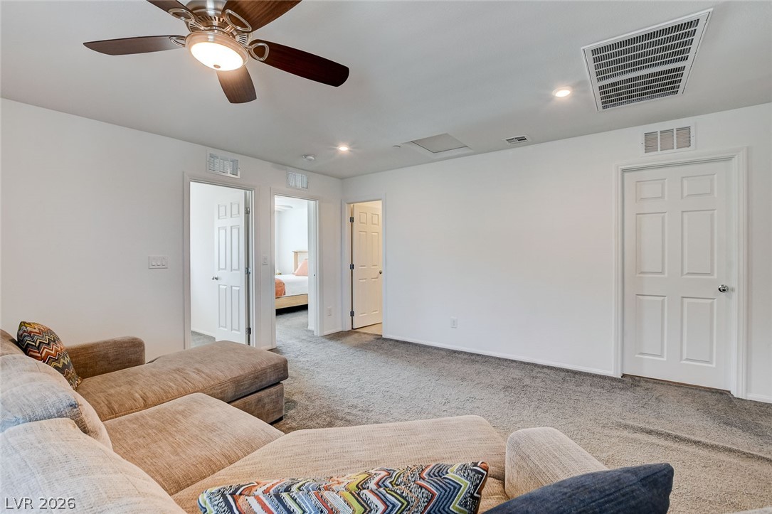 484 Filaree Place Henderson, NV 89015 - Photo 29 of 71 This versatile living space features plush carpet and recessed lighting, creating an inviting atmosphere.