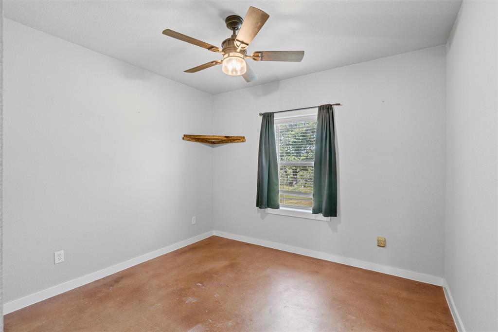 166 South Bronco Court Springtown, TX 76082 - Photo 16 of 40 an empty room with a window and a fan