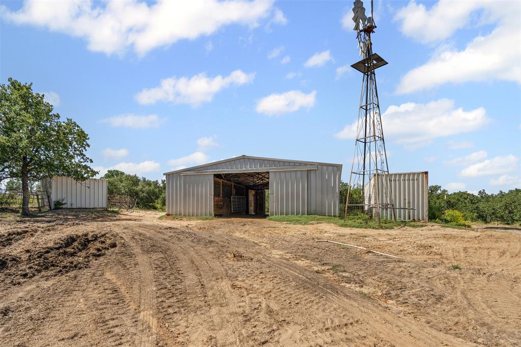 166 South Bronco Court Springtown, TX 76082 - Photo 24 of 40 a front view of a house with a yard and garage