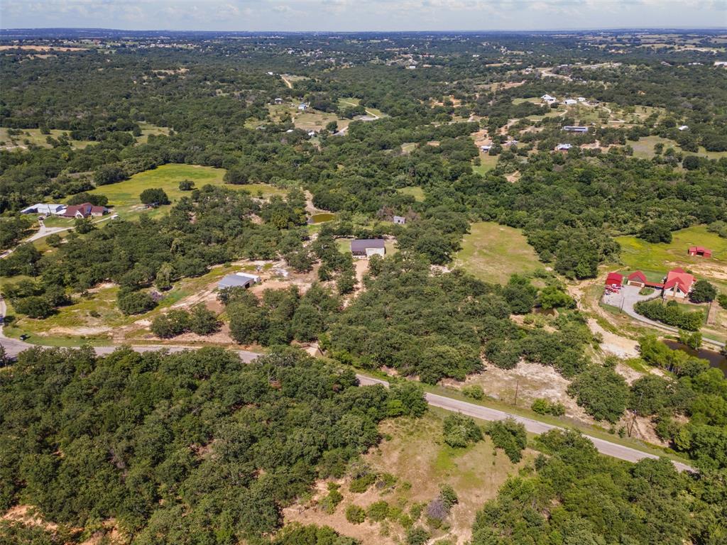 166 South Bronco Court Springtown, TX 76082 - Photo 34 of 40 an aerial view of residential houses with city view