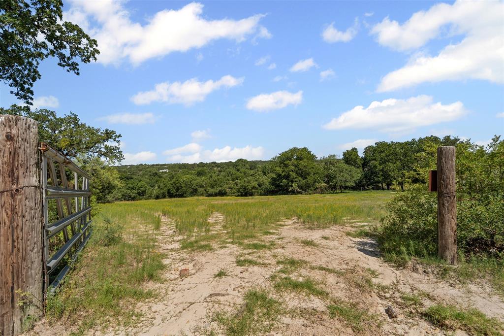 166 South Bronco Court Springtown, TX 76082 - Photo 37 of 40 a view of a lake from a yard