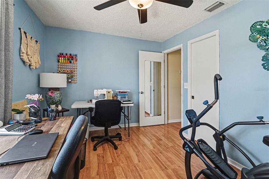 12435 Orangewood Circle Tavares, FL 32778 - Photo 25 of 30 a work room with furniture and a chandelier