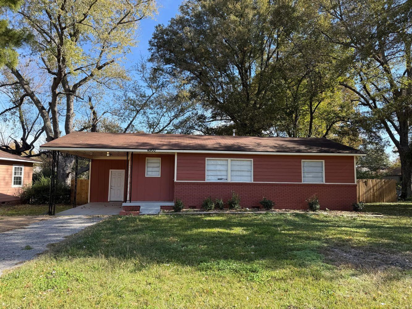 4900 Berta Road Memphis, TN 38109 - Photo 1 of 26 a front view of a house with a garden and yard