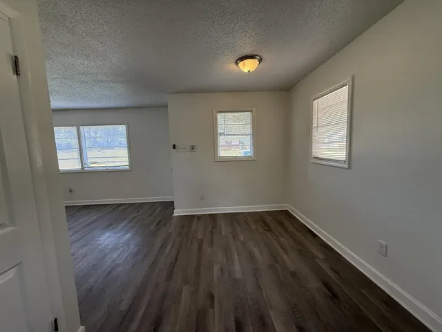 a kitchen with sink a refrigerator and cabinets