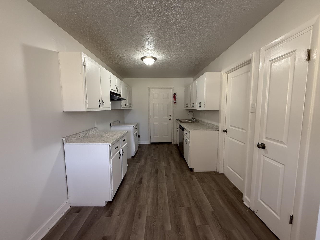 4900 Berta Road Memphis, TN 38109 - Photo 14 of 26 a kitchen with sink a refrigerator and cabinets